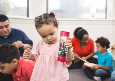 A two year old playing with an instrument