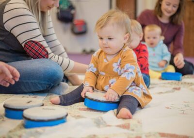 Picture of a baby playing with instrument